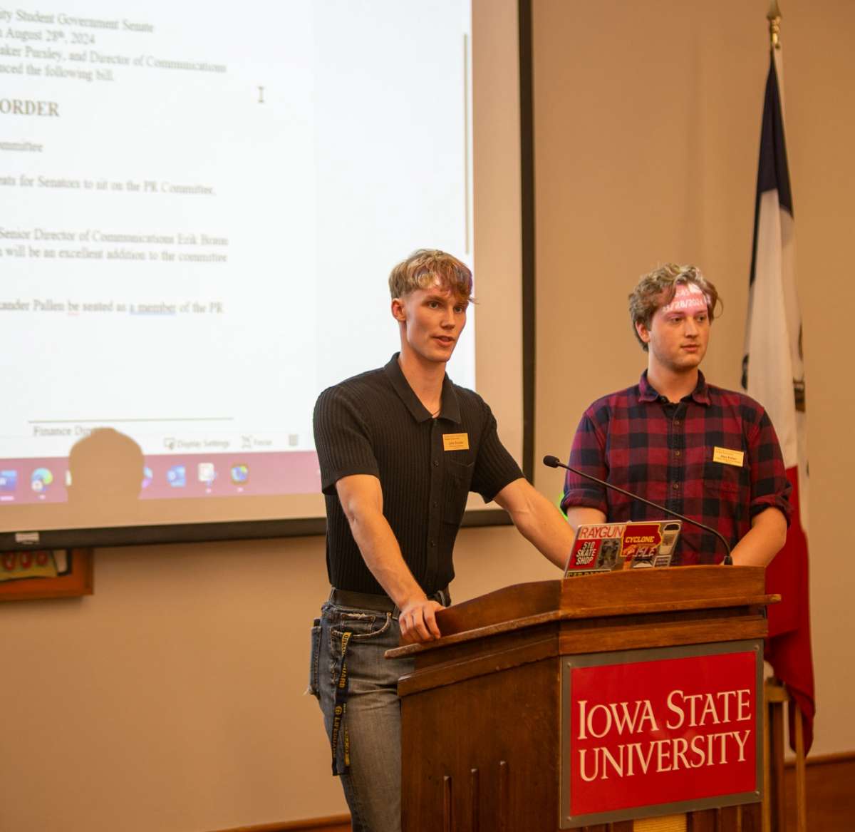 Two people presenting a slideshow presentation.